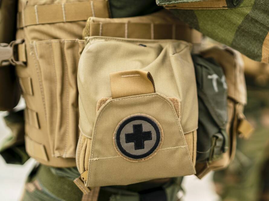 Closeup of a small first aid bag on the uniform of a special force soldier