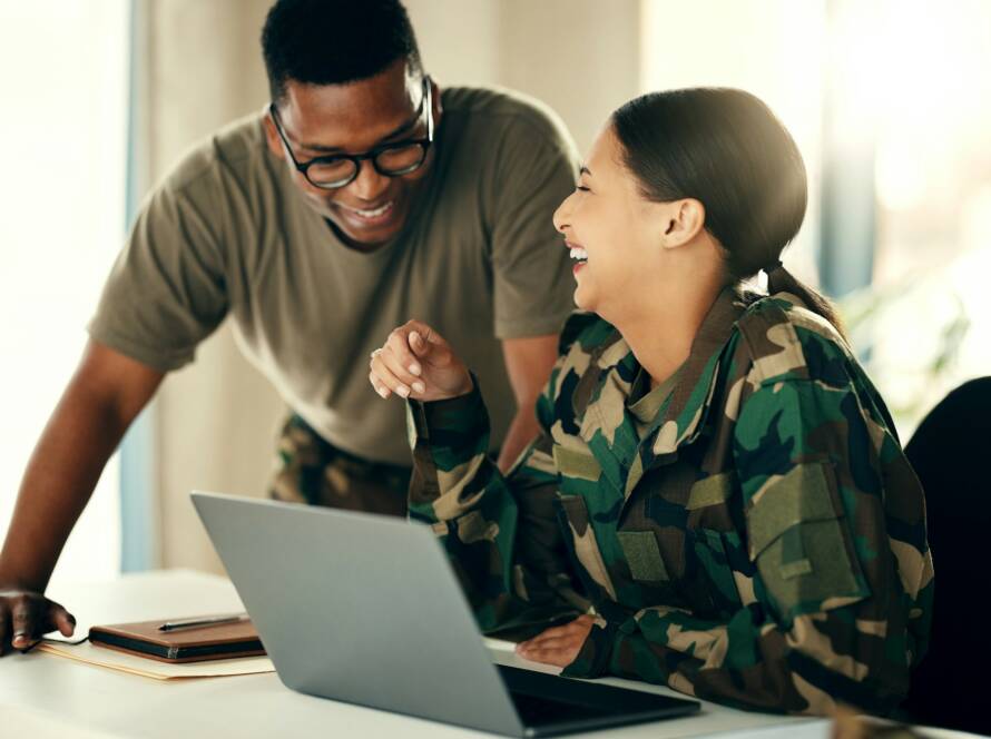 Laptop, friends and a military team laughing in an office on an army base camp together for trainin